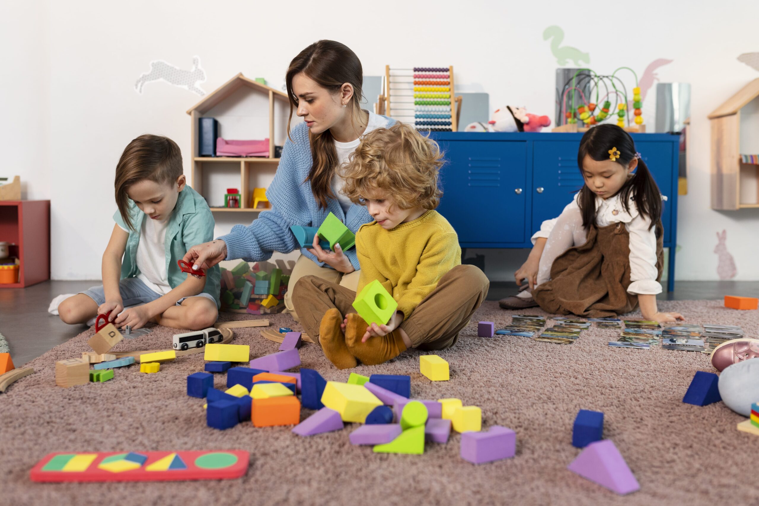 full-shot-little-kids-playing-together-floor (1)-min